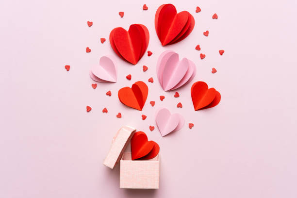 Valentine day composition with gift box and red hearts, photo template on pink background. stock photo
