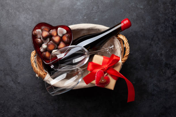 Valentines day basket with wine and chocolate Valentines day basket with wine and chocolate. Top view flat lay happy birthday wine bottle stock pictures, royalty-free photos & images