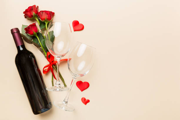 Valentine's day composition with red wine, rose flower and gift box on table. Top view, flat lay. Holiday concept Valentine's day composition with red wine, rose flower and gift box on table. Top view, flat lay. Holiday concept. happy birthday wine bottle stock pictures, royalty-free photos & images