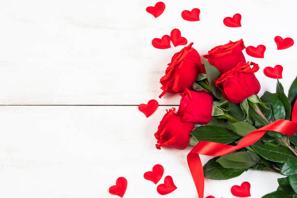 Valentine's day greeting card. Red roses and hearts on a white background. Place for text. stock photo
