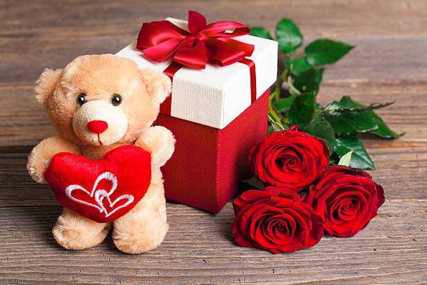 Valentine's Day Teddy Bear Loving with bouquet of Red Roses stock photo