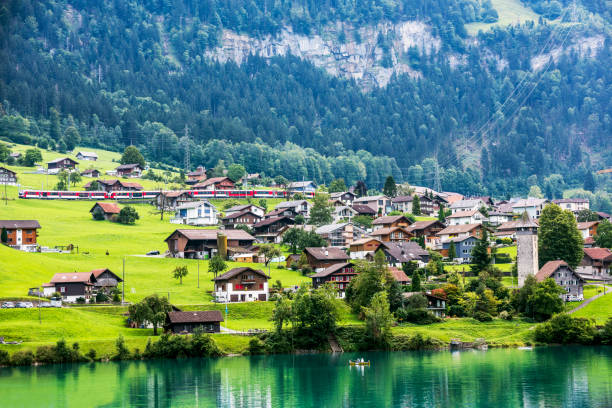 Valley of Lake Lungern or Lungerersee with train in Obwalden, Switzerland Valley of Lake Lungern or Lungerersee with train in Obwalden, Switzerland. lungern village switzerland lake stock pictures, royalty-free photos & images