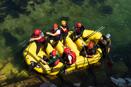 Valstagna (VI), Italy- June 19, 2022: A group of people enjoying white water rafting on the rapids of the Brenta River
