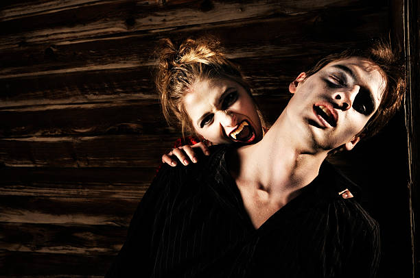 вампир series - man biting womans neck стоковые фото и изображения.