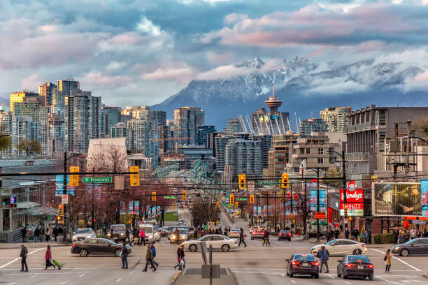 Vancouver City under the mountain A look into the Vancouver downtown and snow mountain across the strait. downtown district stock pictures, royalty-free photos & images