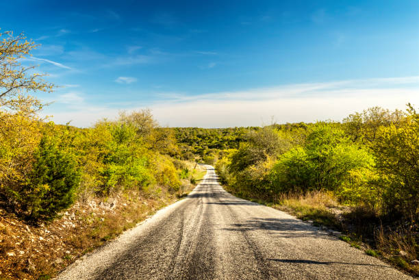 Vanishing highway in Texas Hill Country Vanishing highway in Texas Hill Country east stock pictures, royalty-free photos & images