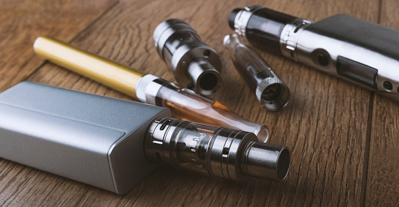 vaping devices or electronic cigarette on a wooden background