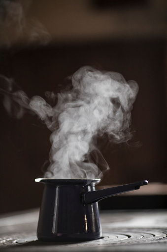 Vapor Coming Out of Coffee Pot on Stove.