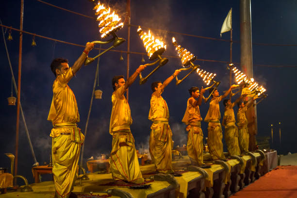 Varanasi morning Ganga aarti rituals performed by young priests before sunrise at the Ganges river ghat at Varanasi India. stock photo