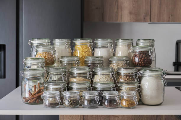 Variety of dry foods, grains, nuts, cereals in glass jars. stock photo