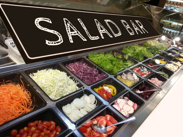 variety of fresh colorful vegetable and fruit at salad bar corner in supermarket with salad bar sign on top stock photo