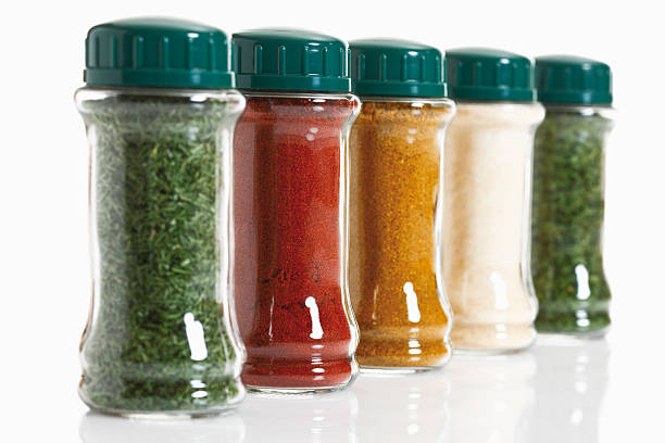 Variety of herbs and spices in glass jar stock photo
