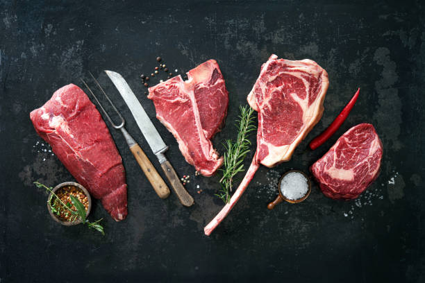 Variety of raw beef meat steaks for grilling Variety of raw beef meat steaks for grilling with seasoning and utensils raw food photos stock pictures, royalty-free photos & images