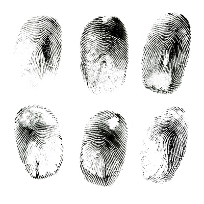 Macro shot of various black ink human fingerprints isolated on white background