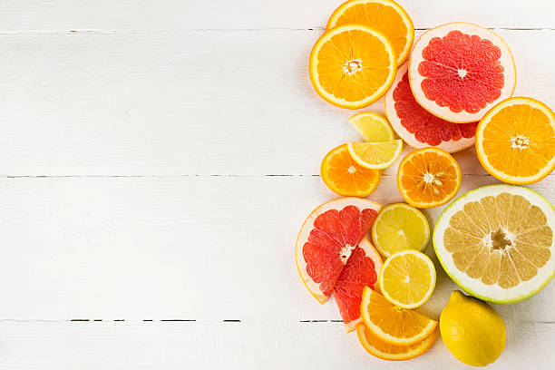 Various citrus on white wooden background  citrus fruit stock pictures, royalty-free photos & images