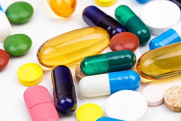 Various color pills and capsules macro shot stock photo