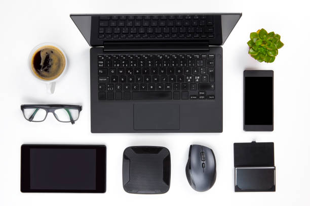 Various Devices Arranged On White Office Desk stock photo