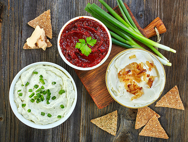 various dip sauces Various dip sauces and bread crackers on wooden table, top view dipping sauce stock pictures, royalty-free photos & images