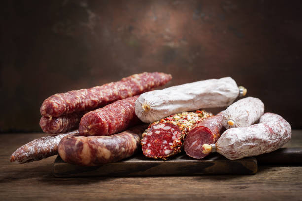 Various kind types of salami and sausages Various kind types of salami and sausages on a wooden board delicatessen photos stock pictures, royalty-free photos & images