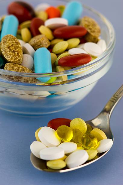 Various medicine pills on a spoon stock photo