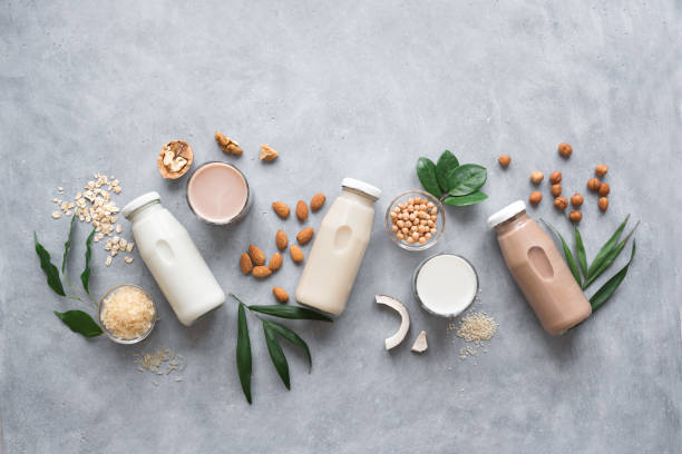 Various Plant Based Milk Various vegan plant based milk and ingredients, top view, copy space. Dairy free milk substitute drink, healthy eating. nut food stock pictures, royalty-free photos & images