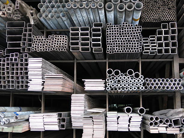 various sizes steel rods and iron profiles stacked up - girder stockfoto's en -beelden