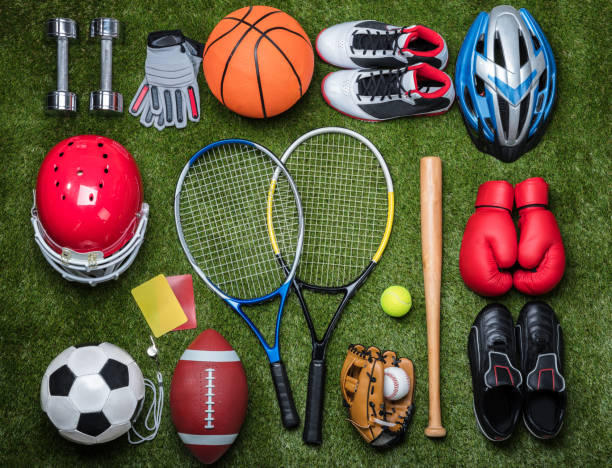 Various Sport Equipments On Grass High Angle View Of Various Sport Equipments On Green Grass base sports equipment stock pictures, royalty-free photos & images