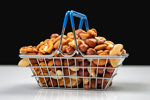 Various types of nuts in the grocery cart. Marketing sale of food products. Vitamin organic protein food
