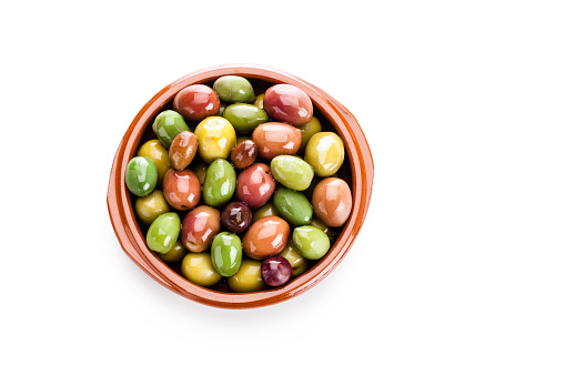 Top view of a brown clay bowl filled with various types of fresh olives isolated on white background. Predominant colors are green and brown. Useful copy space available for text and/or logo. High key DSRL studio photo taken with Canon EOS 5D Mk II and Canon EF 100mm f/2.8L Macro IS USM.