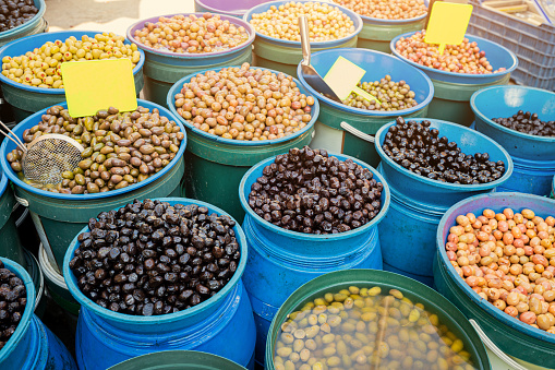 Various types of olives, salted and pickled, are sold at the local farmers market.