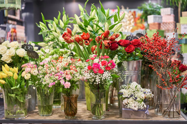 Vases with different colored flowers, showcase flower shop. Beautiful spring bouquets. . Small family business. Work florist. copy space stock photo