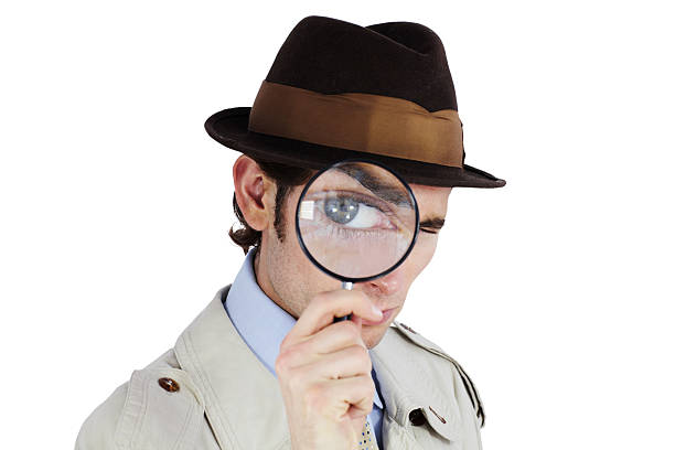 I've got my eye on you! Curious private investigator looking through a magnifying glass against a white background sherlock holmes stock pictures, royalty-free photos & images