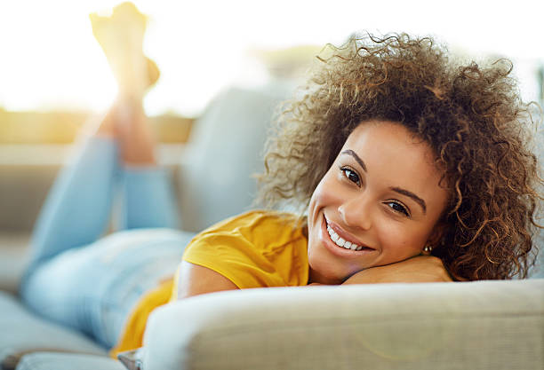 Portrait of a young woman relaxing on the sofa at home