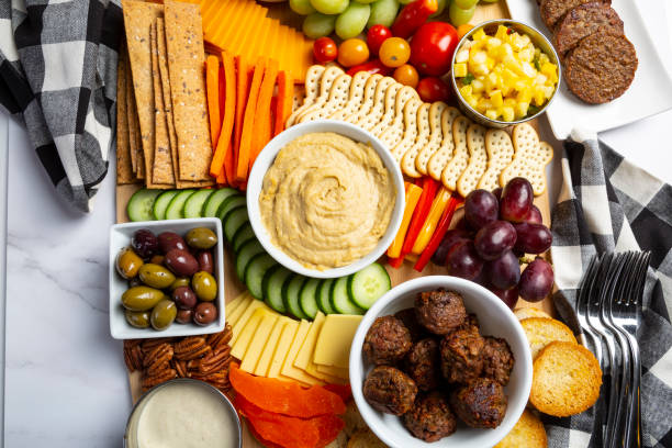 Vegan and vegetarian Charcuterie boards of assorted cheeses, meats and appetizers. Above view table scene on a marble background stock photo