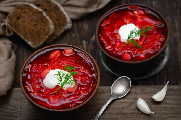 Vegan borscht in bowls on an old wooden background stock photo