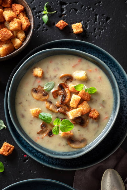 Vegan mushrooms soup with croutons and champignons. stock photo