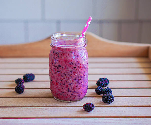 Vegan raw berry smoothie with banana and mixed berries. stock photo