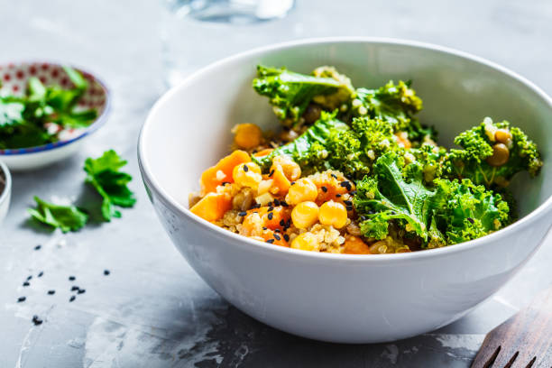 Vegan stew with chickpeas, sweet potato and kale in white bowl. Vegan stew with chickpeas, sweet potato and kale in a white bowl. chick pea stock pictures, royalty-free photos & images
