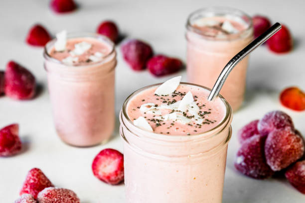 Vegan Strawberry Smoothies Delicious vegan strawberry smoothies prepared by famous chef BVGAN . This photo of these amazing frozen drinks will present itself perfectly on a poster of any professional restaurant. strawberry smoothie stock pictures, royalty-free photos & images