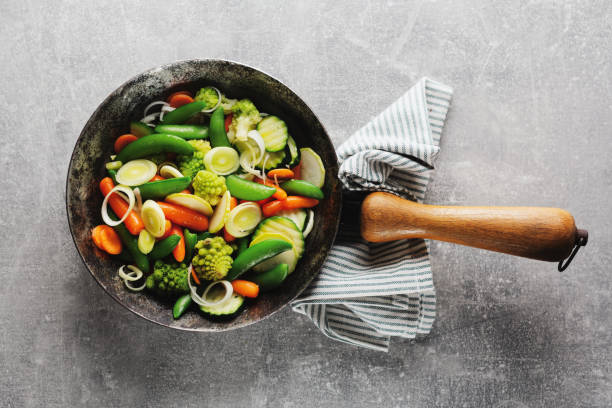 Vegan vegetables on pan on table stock photo