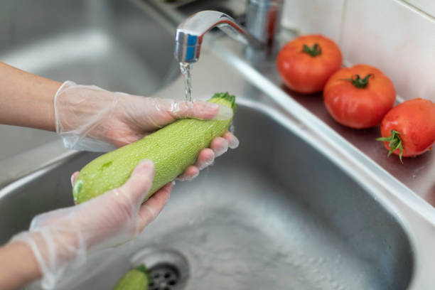 Vegetable cleaning during COVID-19 stock photo