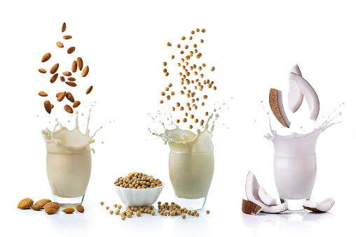 isolated from the white background, some lively vegetarian and organic drinks, with coconut, soy and almonds, alternatives to animal milk