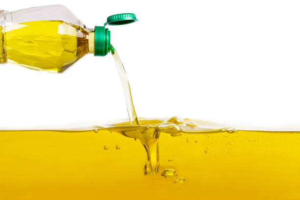 Vegetable oil pouring on vegetable oil background Vegetable oil pouring on vegetable oil background cooking oil stock pictures, royalty-free photos & images