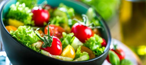 Vegetable salad bowl on kitchen table. Balanced diet stock photo