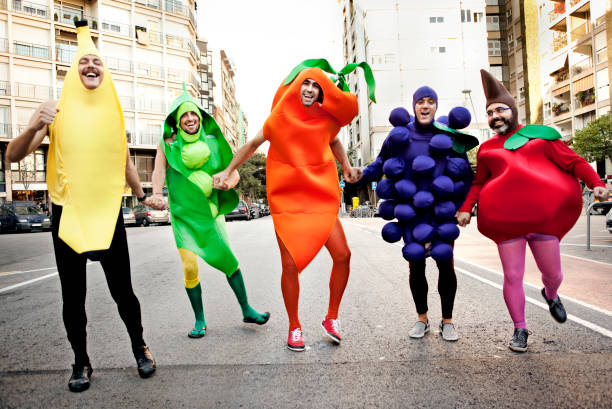 Vegetables Five men dressed up like vegetables running in the street costume stock pictures, royalty-free photos & images
