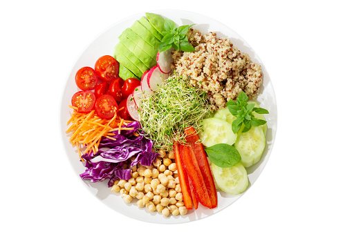 Vegetarian buddha bowl. Plate of healthy salad with quinoa and fresh vegetables isolated on white background, top view