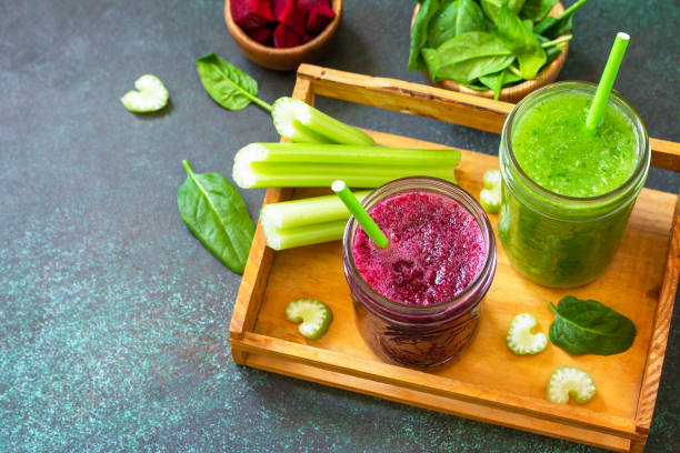 Vegetarian drinks, vegan diet and nutrition, healthy detox concepts. Beet smoothie and Green smoothie celery and spinach on a stone background. Copy space. stock photo