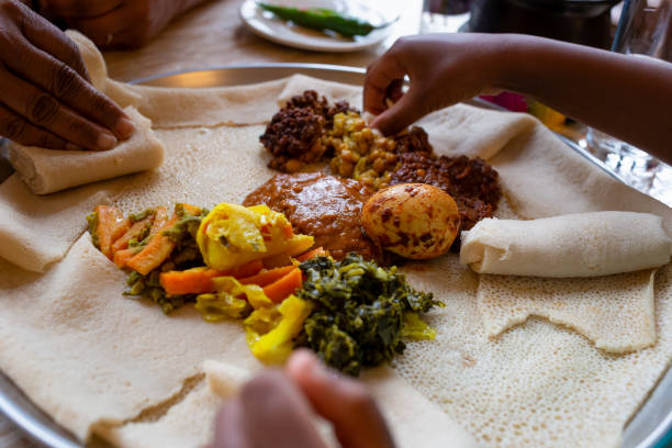 Vegetarian Injera meal with shiro, lentils and egg stock photo