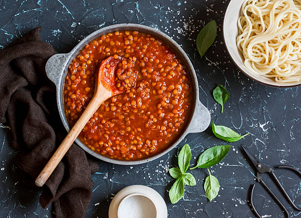 Vegetarian lentil bolognese sauce in a frying pan stock photo