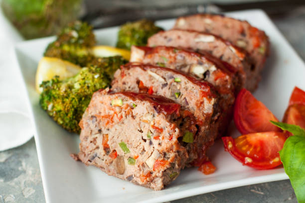 Vegetarian pate in shape of meatloaf Vegetarian pate in shape of meatloaf served with fresh herbs and cherry tomatoes. Healthy homemade food meatloaf stock pictures, royalty-free photos & images